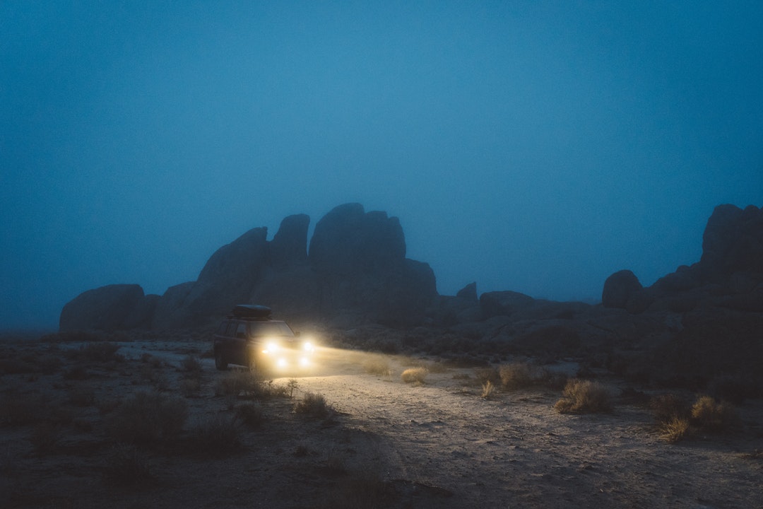 Truck driving in the dark with its headlights on