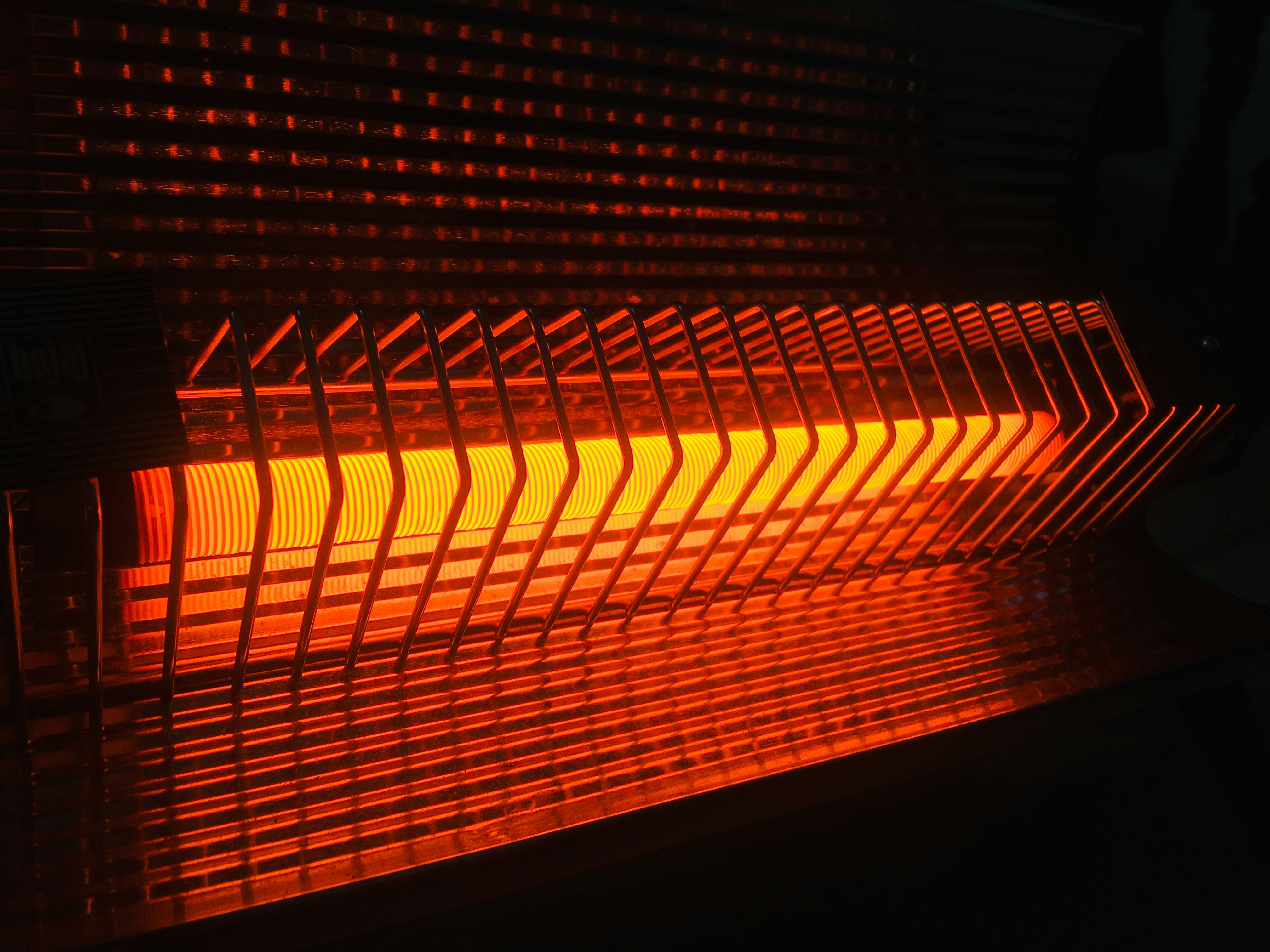 close up of a working heater. Shows a heater glowing a red light because it is on.